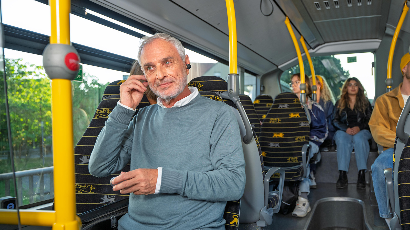 Ein Pendler sitzt im bwregiobus und hat seine Kopfhörer im Ohr